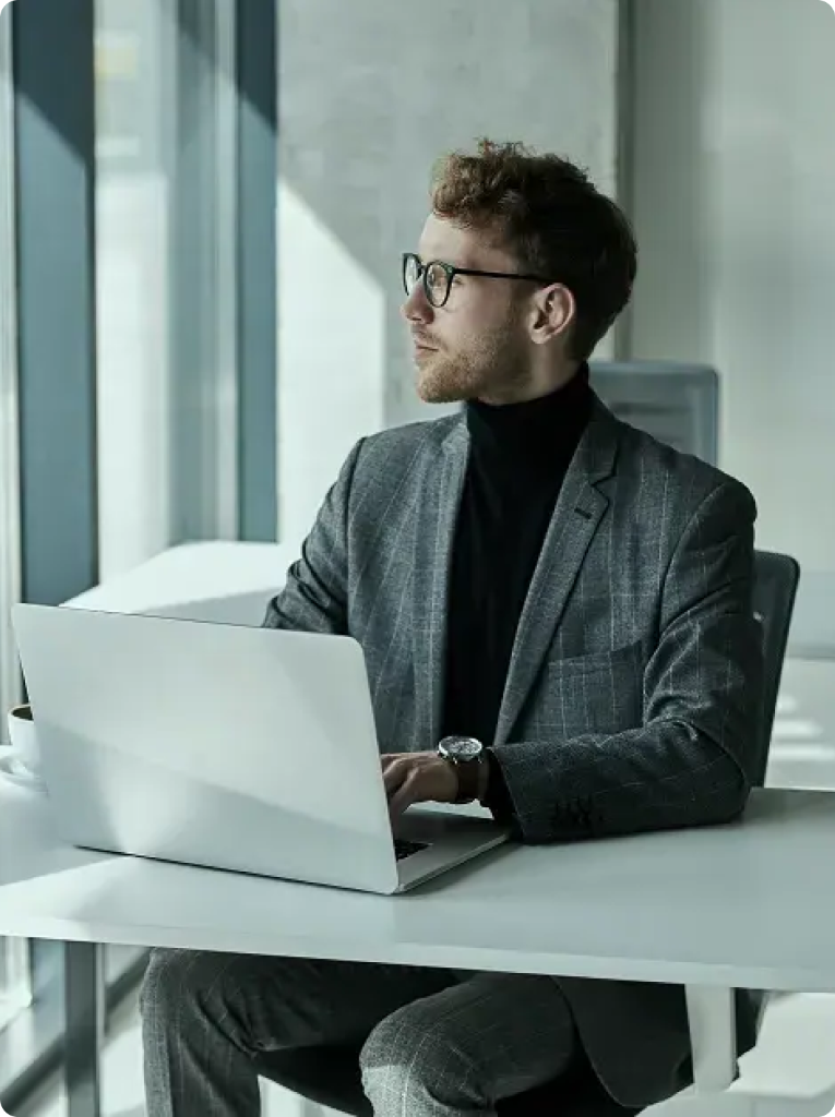Strategic IT and digital marketing consultant working on a laptop